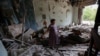 Local resident Valentina Puzanova, 77, stands in her apartment hit by recent shelling in Donetsk, Russian-controlled Ukraine, on September 17.