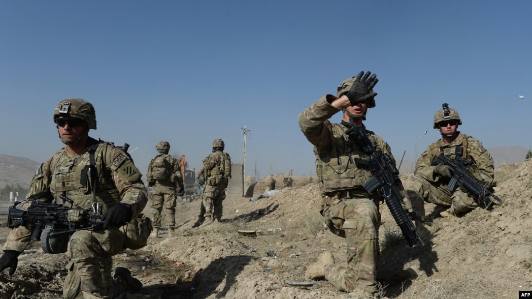 U.S. soldiers stand guard near the site of a suicide attack in Maidan Shar, the capital city of Afghanistan's Wardak Province, in September.