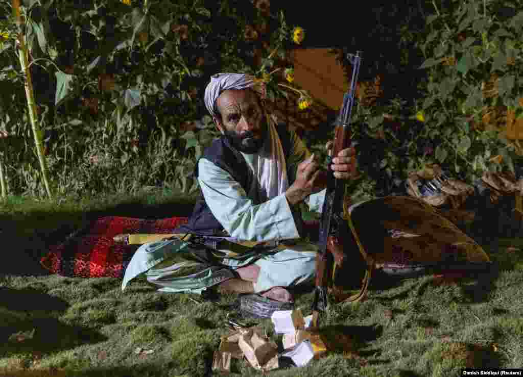 A pro-government militiaman loads his rifle as the special forces visit a government-held base on July 12. Many militias in the country have vowed to fight alongside government troops against the advancing Taliban, which has taken control of dozens of districts in Afghanistan since U.S.-led military forces began withdrawing on May 1.