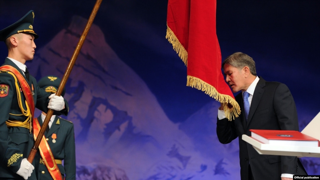 Almazbek Atambaev kisses the Kyrgyz flag during his presidential inauguration ceremony in Bishkek on December 1.