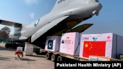 Boxes of the Chinese Sinopharm vaccine for COVID-19 are unloaded from a Pakistan Air Force plane on arrival at Nur Khan Airbase in Rawalpindi on February 1.