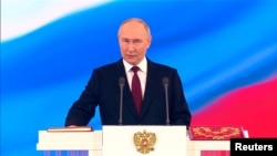 Russian President Vladimir Putin takes the oath during an inauguration ceremony at the Kremlin on May 7.