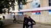 A man tries to raise the black flag of Islamic State militants at an opposition rally in Baku on October 12.