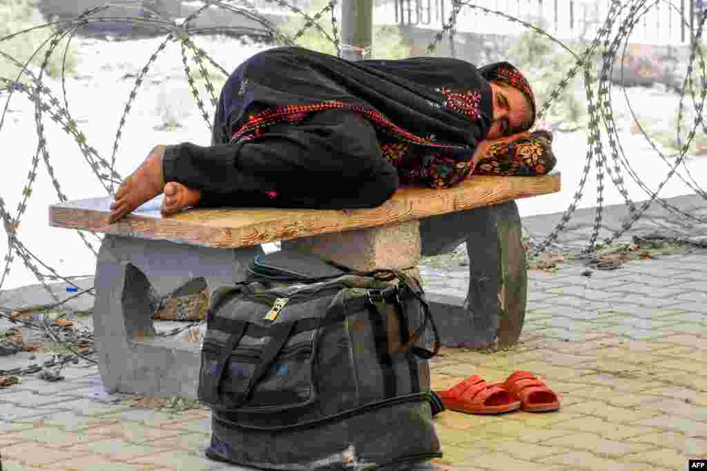 A Pakistani pilgrim who has been evacuated from Iran rests after crossing the Pakistan-Iran border at Taftan in Balochistan Province.