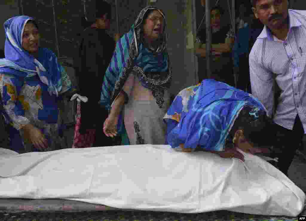 Pakistani Christian relatives of convicted murderer Aftab Bahadur Masih mourn beside his body after his execution in Lahore. Pakistan executed Masih, who was 15 when he was sentenced to death for murder, despite an outcry from human rights groups and the United Nations. Rights group Reprieve said two witnesses who implicated Bahadur had since recanted, saying they were tortured. (AFP/Arif Ali)