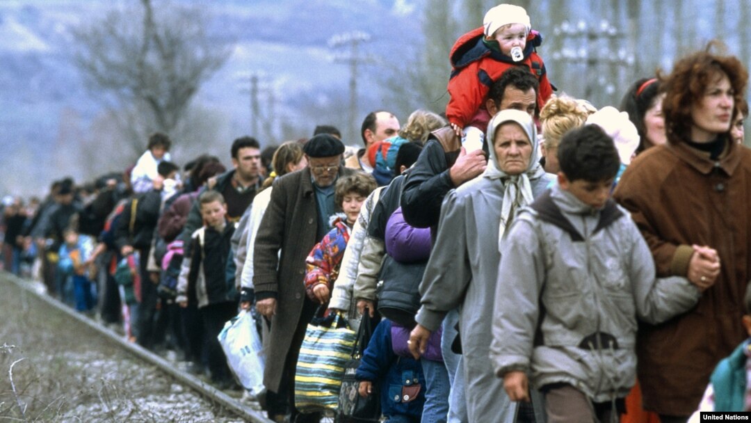 Kosovar refugees flee across the border into Macedonia in March 1999.