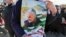 IRAN -- An Iranian man carries a portrait of slain Iranian General Qasem Soleimani, on the 40th day of his killing in a U.S. drone strike, during commemorations marking 41 years since the Islamic Revolution, in Tehran, February 11, 2020
