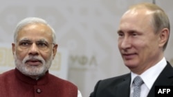 Russian President Vladimir Putin (R) and Indian Prime Minister Narenda Modi arrive for their meeting in Ufa on July 8.