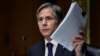 U.S. Secretary of State Antony Blinken holds up documents as he testifies during a Senate Foreign Relations Committee hearing on September 14.