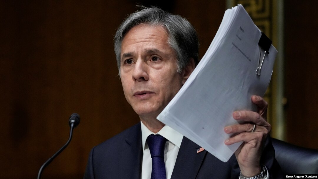 U.S. Secretary of State Antony Blinken holds up documents as he testifies during a Senate Foreign Relations Committee hearing on September 14.