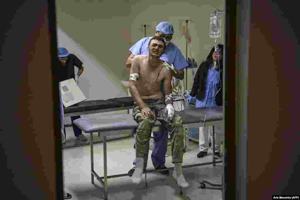 A wounded soldier grimaces in pain as he receives medical care in a hospital outside Stepanakert on October 14. &nbsp;