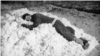 A collective farm worker rests on a pile of cotton. Photo by Max Penson.