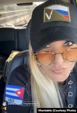 Dayana Diaz, shown here in a social media image, with a Cuban flag on her shoulder. She is one of several people identified who worked with Smirnova to recruit Cubans.