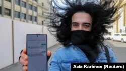 A man in Baku shows his mobile phone with permission to leave home, received in a text message, after the Azerbaijani authorities imposed tough restrictions on free movement in April amid the coronavirus pandemic.