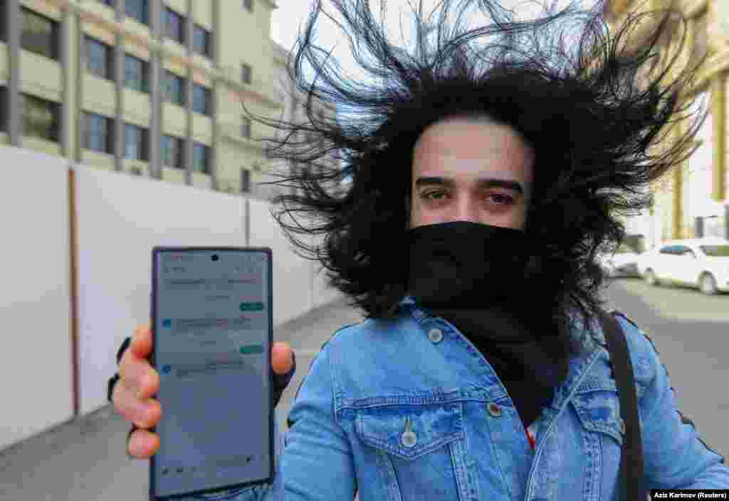 A man shows his mobile phone with his permission to leave home, received in a text message, after the authorities imposed restrictions on movement to prevent the spread of the coronavirus in Baku, Azerbaijan. (Reuters/Aziz Karimov) &nbsp;