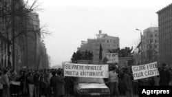 Revoluția Română a pornit din Piața Universității, pe 21 Decembrie 1989. Acolo se ridica până în 1977 Biserica Enei, ctitoria lui Vodă Brâncoveanu. În imagine, manifestanți pe bdul Magheru, a doua zi: „Sf. Vinere dîrmată, dinastia răsturnată”, trimitere la altă biserică demolată.