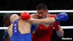 Russia's Yevgeny Tishchenko (R) and Kazakhstan's Vassiliy Levit during an Olympic match which Tishchenko won in a disputed decision.