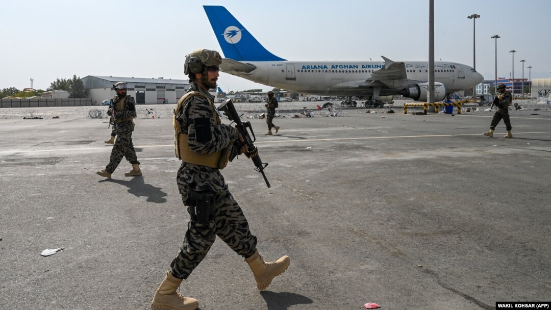 Taliban fighters are seen patrolling the airport in Kabul on August 31, one day after all U.S. troops withdrew.