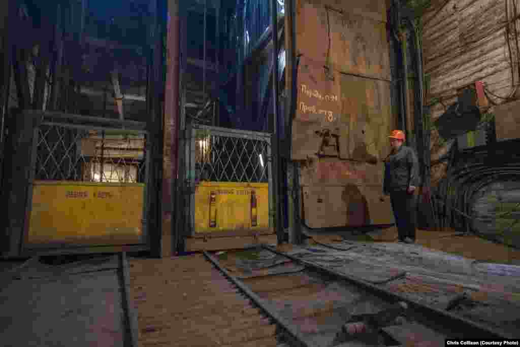 A worker waits as miners ascend to the surface at the Ukraina coal mine. As well as war, coal mines in the east of Ukraine are facing the problem of being unprofitable. As the industry began to decline after the collapse of the Soviet Union in 1991, Ukraine&#39;s government has pumped billions of dollars into keeping the mines functioning.&nbsp;