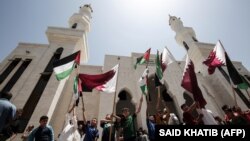 Palestinians attend a rally in support of Qatar, at the Qatari-funded housing project in the southern Gaza Strip city of Khan Yunis on June 9, 2017.