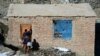 An Afghan health worker marks a door in Kabul to denote that it's been visited by a polio-eradication team on the last day of a vaccination campaign in February.