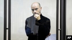 Andrei Pivovarov stands behind the glass during a court hearing in Krasnodar on June 2.