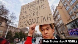 In Almaty, Kazakhstan, a man holds a sign reading: "Coronavirus, we are not afraid of you!"