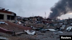 Smoke rises amid damaged buildings following an attack on the Yavoriv military base in Ukraine on March 13. 