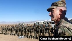 U.S. Army General John Nicholson speaks with Afghan police special forces after they took part in a military exercise in November.