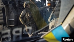 A Ukrainian soldier stands near a military vehicle amid Russia's attack on Ukraine in the frontline city of Bakhmut on February 19.