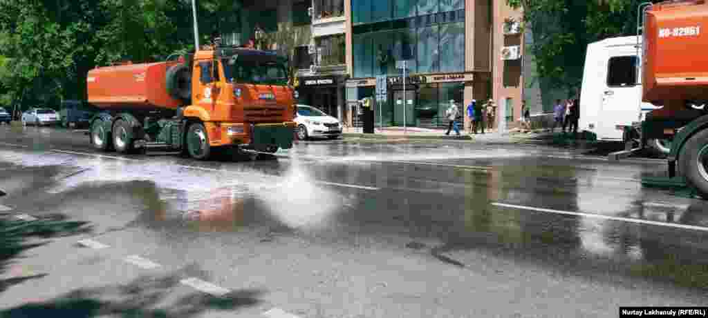 Vehicles spray disinfectant on a road near the site of a planned opposition rally in Almaty.