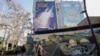A billboard depicting an Iranian missile with a phrase in Persian that reads "Prepare your coffins" hangs on the side of a building in Tehran on January 16.