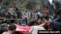 Locals search for victims of a mudslide following heavy flooding in Nuristan Province.