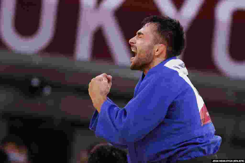Vazha Margvelashvili of Georgia (blue) celebrates after defeating Baul An of South Korea (white) during their bout in the Men&#39;s -66kg Semifinal of Table B Judo events of the Tokyo 2020 Olympic Games at the Nippon Budokan arena in Tokyo, Japan, 25 July 2021.&nbsp;Vazha Margvelashvili of Georgia took silver.&nbsp;