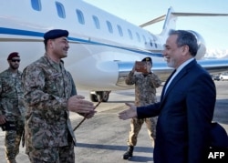 Iranian Foreign Minister Abbas Araqchi (right) welcomes Pakistani army chief Asim Munir upon his arrival in Tehran on April 15.