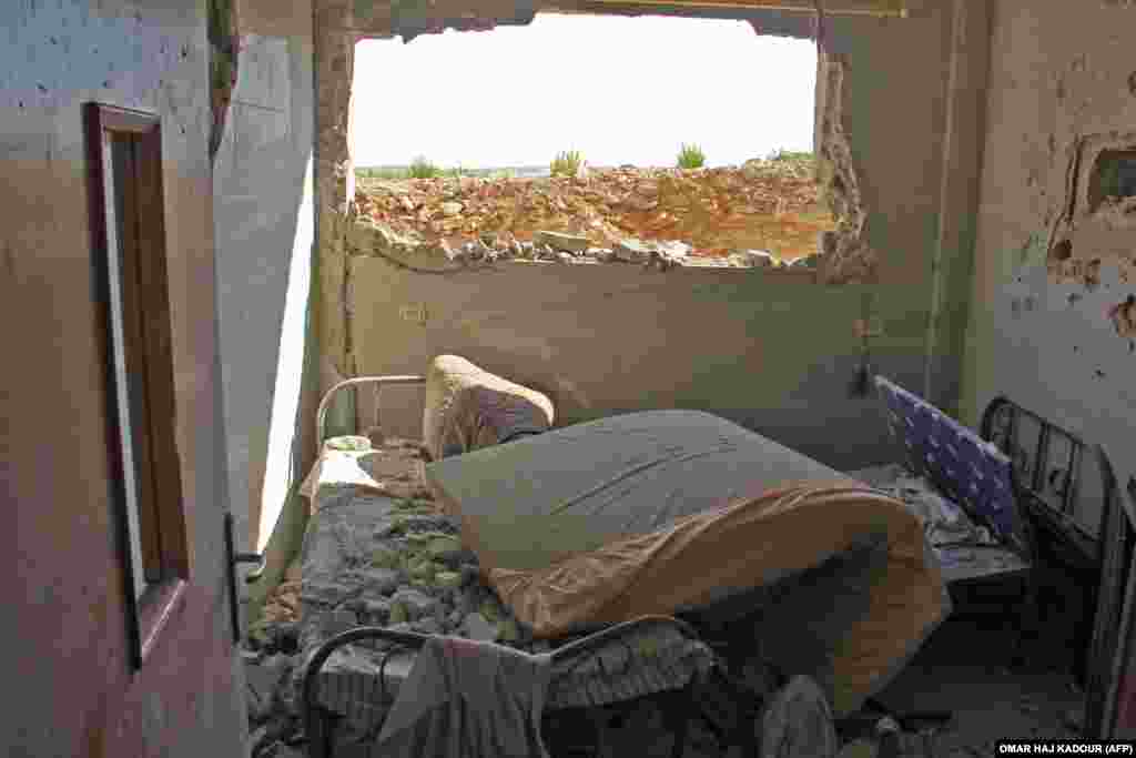 A picture taken on September 19 shows hospital beds covered in rubble and debris following a reported air strike by Syrian government forces in the village of Al-Tahh, in the northwestern Idlib Province. (AFP/Omar Haj Kadour)