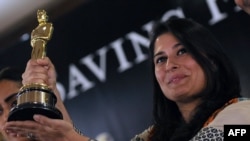 Pakistani director Sharmeen Obaid-Chinoy poses for photographs with the Academy Award she won in 2012 for a documentary on acid attacks on Pakistani women. Her latest movie tackles the subject of 'honor killings' in Pakistan, which she says claims the lives of hundreds of women every year.