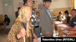 An eldery woman casts her ballot in the village of Costesti.