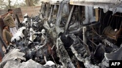 Burned-out vehicles at a NATO supply camp in Peshawar on December 1.