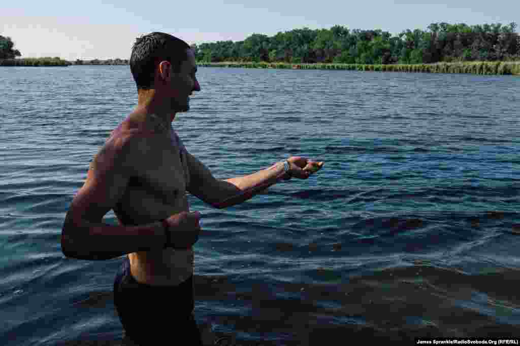 Dice pulls in a fishing line during a swimming trip outside of Pisky.&nbsp;