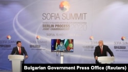 Bulgarian Prime Minister Boyko Borisov (right) and his North Macedonia counterpart Zoran Zaev give statements with German Chancellor Angela Merkel, attending via video link, in Sofia on November 10.