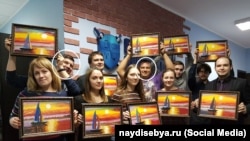 In this undated photo taken from social media, Oleg Dayvdov (left), Oleg Fyodorov (right) and other Oxygen Software employees, are seen at a company event.