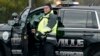 A law enforcement official stands patrol on a main road leading to Congregation Beth Israel synagogue where a man held hostages for hours on January 15.