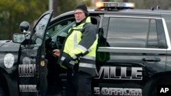 A law enforcement official stands patrol on a main road leading to Congregation Beth Israel synagogue where a man held hostages for hours on January 15.