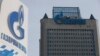 Russia -- A view shows a sign of a petrol station of Gazprom Neft company and the headquarters of the Russian natural gas producer Gazprom in Moscow, February 24, 2015