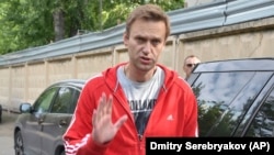 Aleksei Navalny greets colleagues as he leaves a detention center in Moscow on June 14.