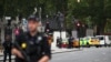 Armed police stand in the street after a car crashed outside the Houses of Parliament in Westminster, London, on August 14. 