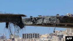 A view of the B1 bridge is pictured after it was destroyed by a strike in Karaj, around 20miles (35kms) southwest of Tehran.