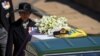 A military hat rests on the coffin of Prince Philip as it is transported by the hearse, a specially modified Land Rover, during the funeral of Britain's Prince Philip, husband of Queen Elizabeth, who died at the age of 99, on the grounds of Windsor Castle