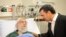 A handout photo provided by the office of Iran's supreme leader Ayatollah Ali Khamenei shows former president Mahmoud Ahmadinejad visiting him at a hospital in Tehran on September 8, 2014, after his prostate operation. 